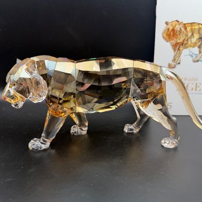 Sale Photo Thumbnail #46: Swarovski crystal annual edition tiger figurine in golden shadow crystal, complete with original box and paperwork.