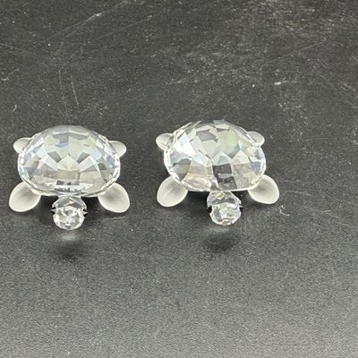 Sale Photo Thumbnail #29: Pair of Swarovski crystal sea turtle figurines with faceted shells and frosted flippers.