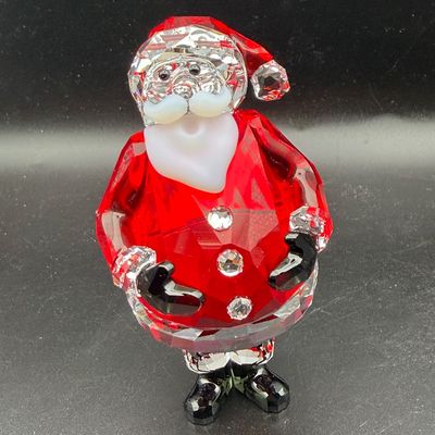 Sale Photo Thumbnail #22: Swarovski crystal Santa Claus figurine featuring a faceted red coat, clear crystal accents, frosted glass beard, and black boots.