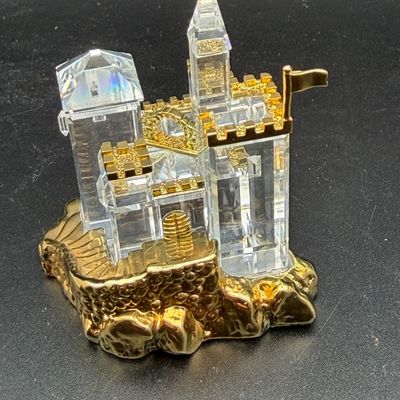 Sale Photo Thumbnail #41: Swarovski style crystal castle figurine with gold-tone metal base and accents.