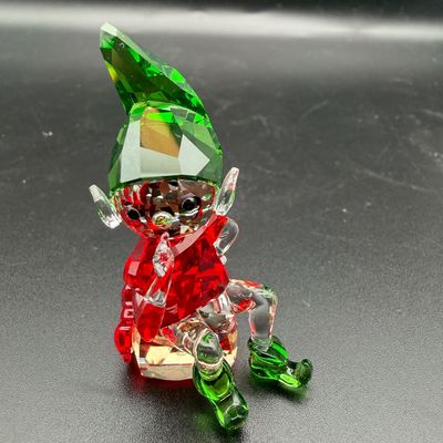 Sale Photo Thumbnail #7: Swarovski crystal Christmas elf figurine in red, green, and clear faceted glass, shown in excellent condition.