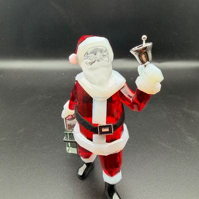Sale Photo Thumbnail #21: Swarovski crystal Santa Claus figurine, featuring faceted red crystal suit, clear face, frosted white trim, and a silver-tone metal handbell.