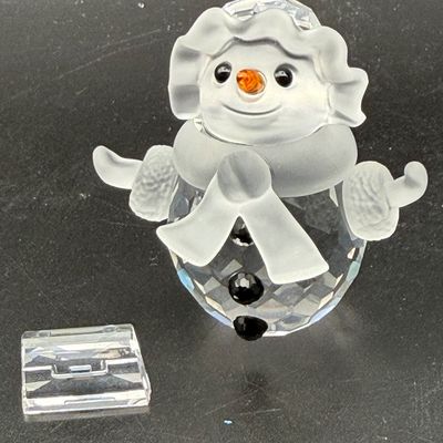 Sale Photo Thumbnail #15: Swarovski crystal snowman figurine with frosted glass scarf, hat, and arms, featuring an orange crystal nose and black accents.