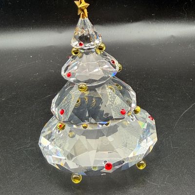 Sale Photo Thumbnail #19: Faceted crystal Christmas tree figurine adorned with red and gold colored ornaments and topped with a gold-tone star topper.