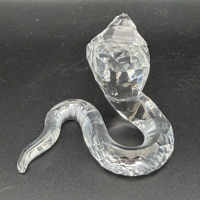 Sale Photo Thumbnail #30: Swarovski crystal cobra figurine featuring a faceted, rearing snake design in clear crystal.