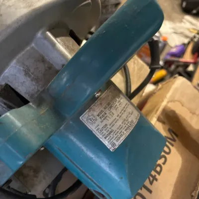Vintage teal 7 1/4-inch circular saw showing model specification label, displaying cosmetic wear from use.