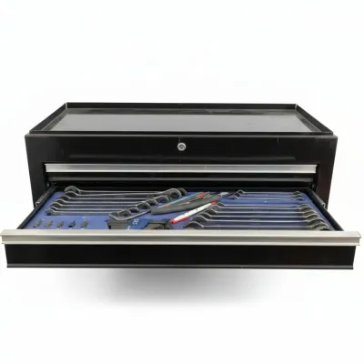 Black metal top-chest tool box featuring an open drawer filled with organized wrenches, hex keys, and hand tools on a blue foam insert.