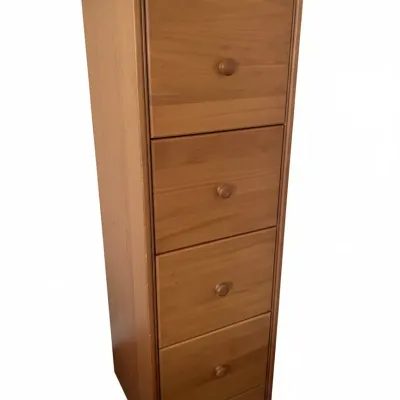Tall narrow light pine four-drawer filing cabinet with round wooden knobs.