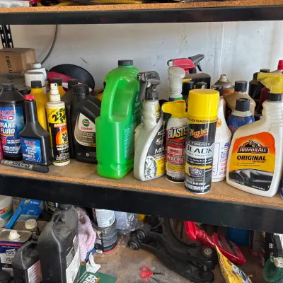 Shelves filled with various automotive fluids, cleaning products, and maintenance sprays including Armor All, Meguiar's, and Castrol.
