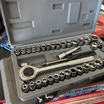 Complete socket and ratchet set in a gray molded plastic storage case.