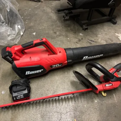 Bauer 20V cordless leaf blower and hedge trimmer set, complete with battery pack and rapid charger.