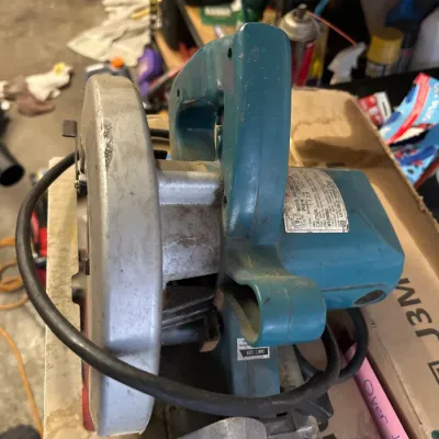 Makita 7 1/4-inch corded circular saw, showing heavy usage wear consistent with workshop use.