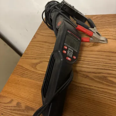 Innova digital timing light with tachometer, featuring wrapped lead wires and battery clamps.
