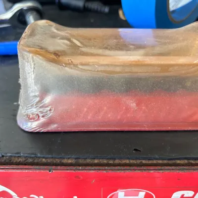 Vintage Milwaukee Tool red plastic storage box containing small parts, sealed in shrink wrap.