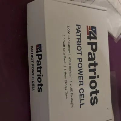 New in box 4Patriots Patriot Power Cell featuring an 8,000 mAh battery, 1.5-watt solar panel, and 2 LED flashlights.