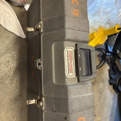 Vintage Professional Tuff-Box molded plastic hard carrying case with metal latches, displaying surface wear and orange stencil lettering.