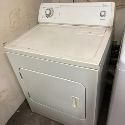 White Whirlpool electric clothes dryer featuring a front-loading door, top lint trap, and simple analog control dials.