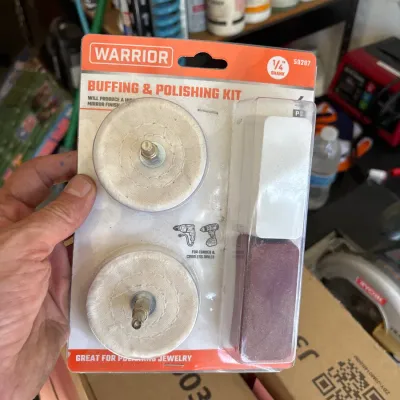 Warrior buffing and polishing kit in original blister packaging, featuring two polishing wheels and compound bars for drill attachments.