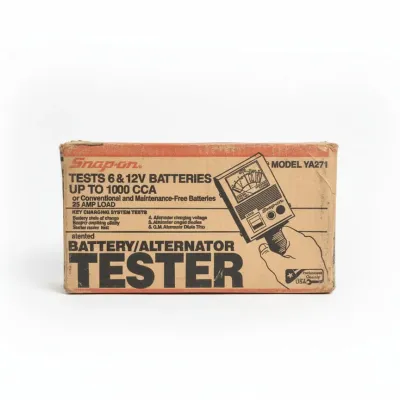 Vintage Snap-on battery and alternator tester model YA271 in its original cardboard box, showing light shelf wear.