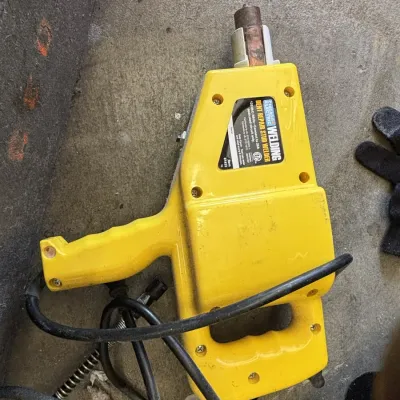 Chicago Electric dent repair stud welder in a yellow plastic housing, model 61433.
