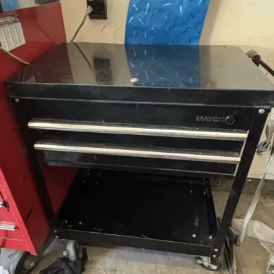Black Matco Tools rolling service cart featuring two drawers, a top compartment, and a bottom shelf.