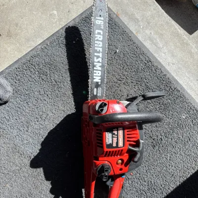 Craftsman gas-powered chainsaw featuring a 16-inch bar and 36cc engine with a red casing.