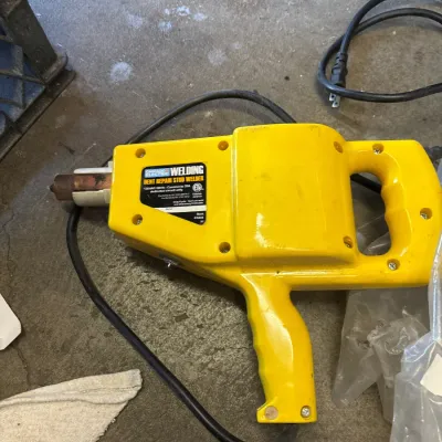 Chicago Electric Welding dent repair stud welder in bright yellow casing, complete with power cord.