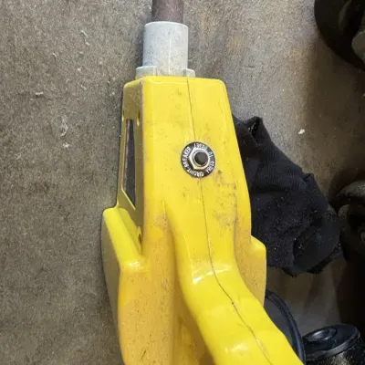 Yellow electric jackhammer or power tool featuring a circuit breaker reset button on the housing.