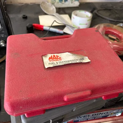 Mac Tools fuel and transmission line disconnect tool set in its original red blow-molded storage case.