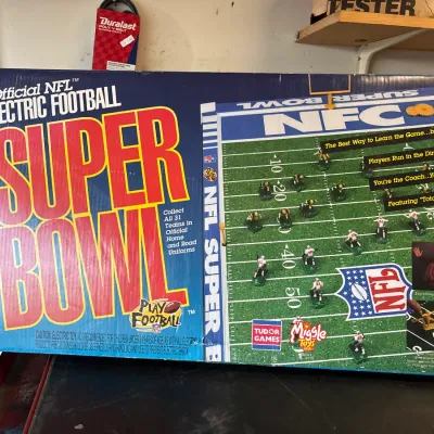 Vintage Tudor Games Miggle Toys Official NFL Super Bowl Electric Football game in original box, showing some edge wear.