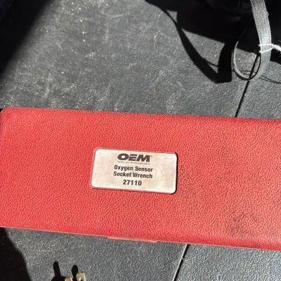 OEM Tools red molded plastic storage case for an oxygen sensor socket wrench, model 27110.