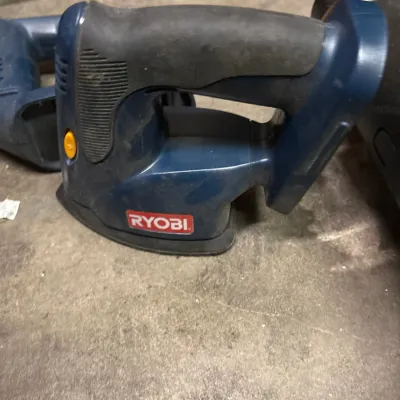 Used blue and black Ryobi cordless corner cat finish sander showing minor dust and wear.