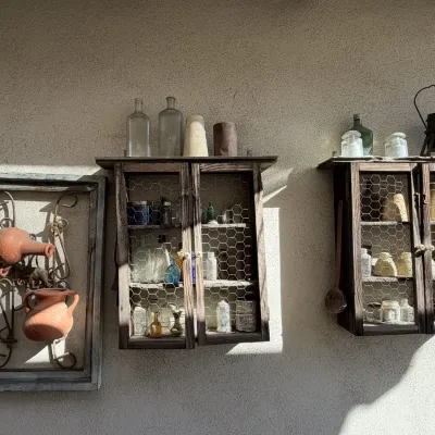 Rustic Wall Cabinets with Chicken Wire Doors, Antique Bottles and Insulators