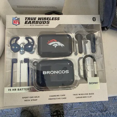 Sale Photo Thumbnail #156: Denver Broncos NFL true wireless earbuds with charging case and accessories in original retail packaging.
