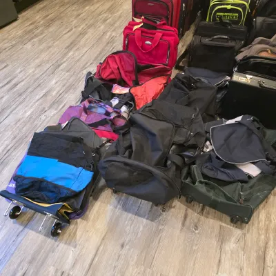 Sale Photo Thumbnail #46: Large assortment of assorted luggage, rolling duffel bags, backpacks, and briefcases in various colors and styles.
