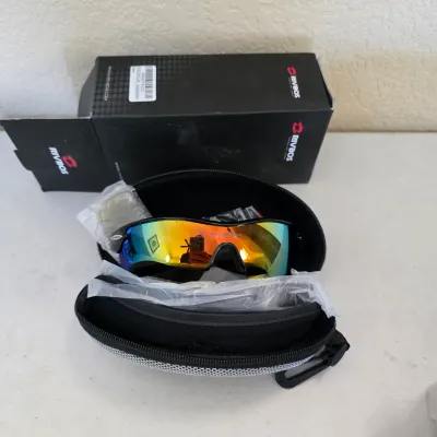 Sale Photo Thumbnail #154: Rivbos sports sunglasses with polarized rainbow mirrored lenses, displayed in a zip-around hard case with original packaging.