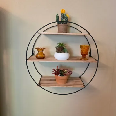 Sale Photo Thumbnail #73: Modern circular metal and wood three-tier wall shelf unit displayed with potted faux succulents and amber glassware.