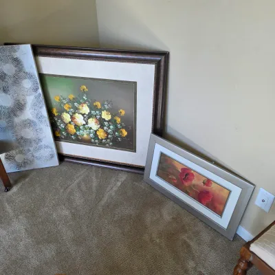 Sale Photo Thumbnail #95: Collection of framed floral artwork and a textured modern canvas art piece resting against a wall.
