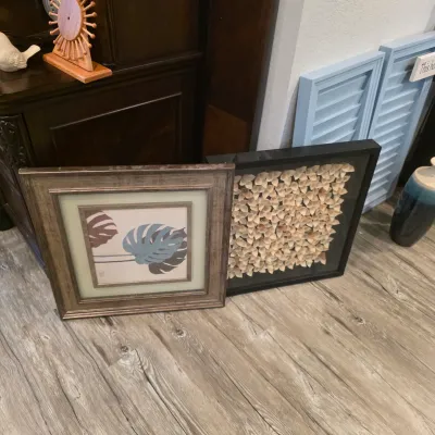 Sale Photo Thumbnail #39: Pair of framed wall art pieces, including a monstera leaf print in a textured metallic frame and a black shadow box with paper flower embellishments.