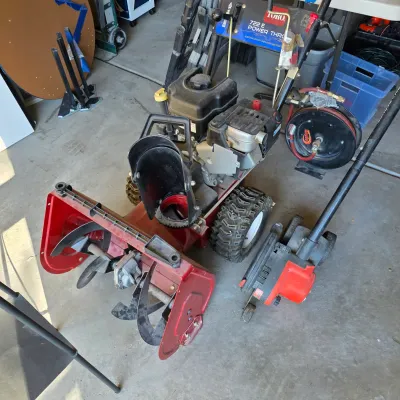 Sale Photo Thumbnail #130: Toro 722 E Power Throw gas snowblower featuring electric start, heavy-duty treaded tires, and an adjustable discharge chute.
