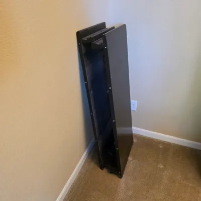 Sale Photo Thumbnail #77: Folded black wooden utility or banquet table leaning against a wall.