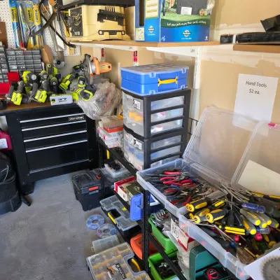 Sale Photo Thumbnail #149: Workshop area filled with various hand tools, power tools, plastic storage organizers, and a black Craftsman rolling tool chest.