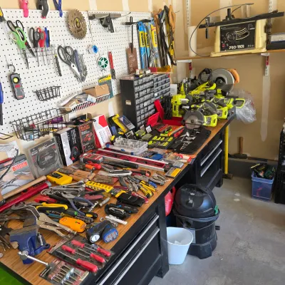 Sale Photo Thumbnail #121: Workshop bench and pegboard packed with various hand tools, Ryobi power tools, hardware organizers, and benchtop equipment.