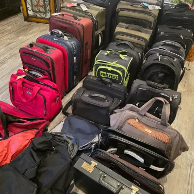 Sale Photo Thumbnail #45: Large collection of luggage, including rolling suitcases, duffel bags, backpacks, and laptop cases in various sizes and colors.