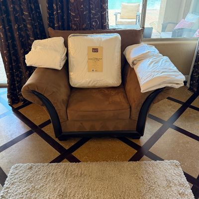 Sale Photo Thumbnail #45: Brown microfiber armchair displaying packaged bedding, including a down alternative comforter and white sheet sets.
