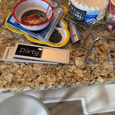 Sale Photo Thumbnail #196: Assorted kitchen items including a Disney Cars children's bowl, character plate, paper coffee filters, metal racks, and dishwasher status sign.