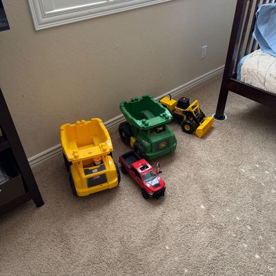 Sale Photo Thumbnail #6: Collection of plastic toy construction vehicles and a red pickup truck, including Mega Bloks CAT and John Deere dump trucks.