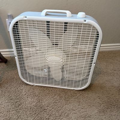 Sale Photo Thumbnail #120: White Lasko portable 20-inch box fan, featuring a top carrying handle and three-speed rotary dial control.