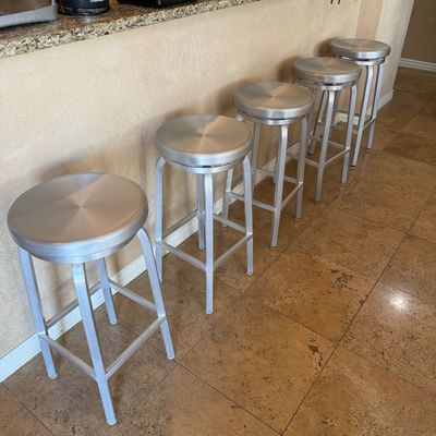 Sale Photo Thumbnail #213: Set of five modern brushed aluminum backless barstools with swivel seats and footrests.