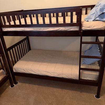 Sale Photo Thumbnail #64: Dark wood bunk bed frame with attached ladder, safety rails, and mattresses included.